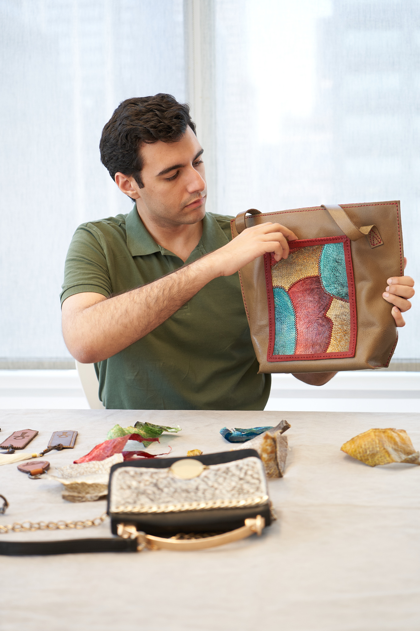 Visenleer founder presenting a tote with a colourful textured panel